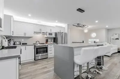 a kitchen with white cabinets and white appliances at Innisfil retreat, hot tub, Sauna, EV plug, Generac in Innisfil