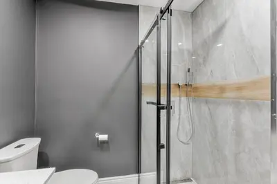 a bathroom with a glass shower with a toilet at Innisfil retreat, hot tub, Sauna, EV plug, Generac in Innisfil