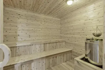 a wooden sauna with a bench in a room at Innisfil retreat, hot tub, Sauna, EV plug, Generac in Innisfil