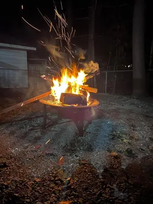 a fire pit in a yard at night at Innisfil retreat, hot tub, Sauna, EV plug, Generac in Innisfil