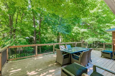 a patio with a table and chairs on a deck at Innisfil retreat, hot tub, Sauna, EV plug, Generac in Innisfil