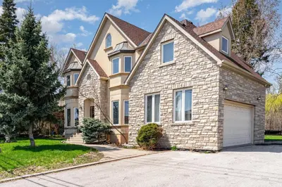 a large brick house with a garage at Home in Richmond Hill in Richmond Hill