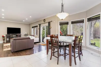 a dining room with a table and chairs and a couch at Home in Richmond Hill in Richmond Hill