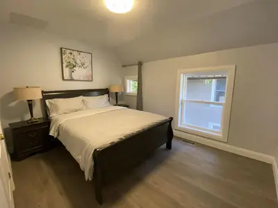 a bedroom with a large bed and a window at Rock place in Niagara Falls