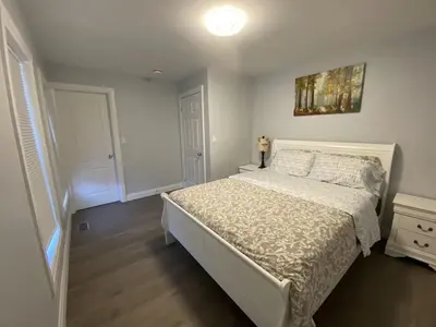 a bedroom with a bed and a painting on the wall at Rock place in Niagara Falls