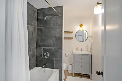a bathroom with a white tub and a sink at The Willow Suite Near DT & Hospital in Peterborough