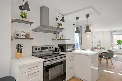 a kitchen with white cabinets and a stove top oven at The Willow Suite Near DT & Hospital in Peterborough