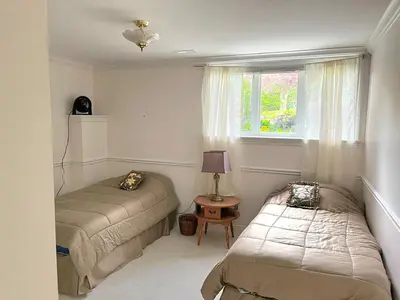 a bedroom with two beds and a window at Summer Escape Close to the City in Newmarket