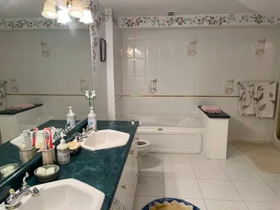 a bathroom with two sinks and a toilet and a tub at Summer Escape Close to the City in Newmarket