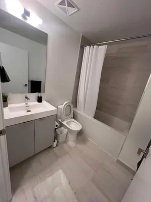 a bathroom with a toilet and a sink and a shower at Vaughan Cozy 1 Bedroom Condo in Vaughan