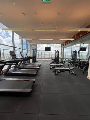 a gym with rows of treadmills and machines at Vaughan Cozy 1 Bedroom Condo in Vaughan