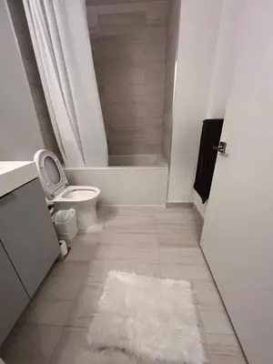 a bathroom with a toilet and a bath tub at Vaughan Cozy 1 Bedroom Condo in Vaughan