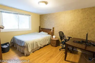 a bedroom with a bed and a desk with a television at HB GUEST HOME 2-entire house U3 beds in Waterloo