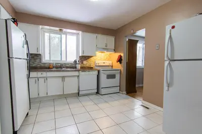 a kitchen with white appliances and white cabinets at HB GUEST HOME 2-entire house U3 beds in Waterloo