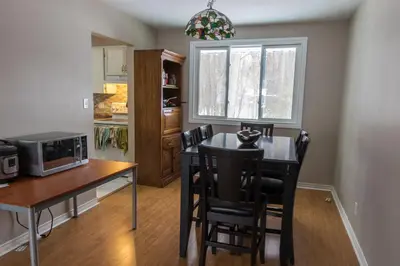 a kitchen with a table with chairs and a microwave at HB GUEST HOME 2-entire house U3 beds in Waterloo