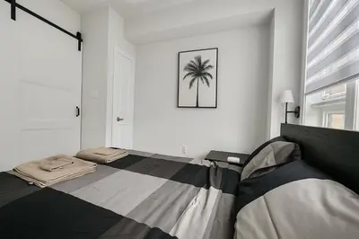 a bedroom with a bed with a palm tree on the wall at Vellore's Ritz and Rest House in Vaughan