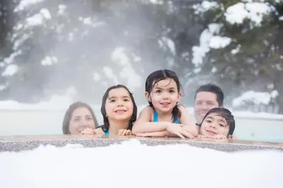 a group of people swimming in a bathtub at Blue Mountain Resort Village Suites in Blue Mountains
