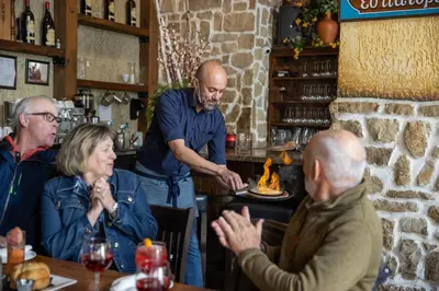 a group of people sitting at a table in a bar at Blue Mountain Resort Village Suites in Blue Mountains