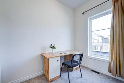 a desk and a chair in a room with a window at Richland Modern Luxury house in Richmond Hill