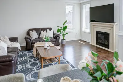 a living room with couches and a fireplace at Richland Modern Luxury house in Richmond Hill