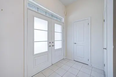 a white room with two doors and a tiled floor at Richland Modern Luxury house in Richmond Hill