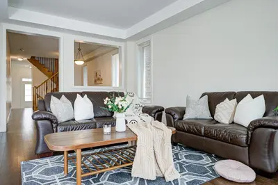 a living room with a leather couch and a coffee table at Richland Modern Luxury house in Richmond Hill