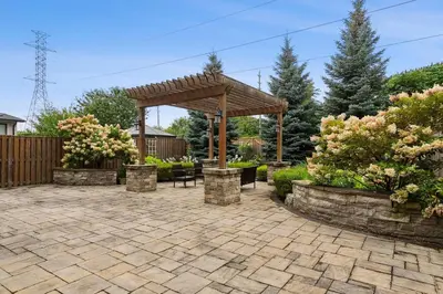 a patio with a wooden pergola in a yard at Quiet Getaway Perfect for Families and Retreats in Mississauga