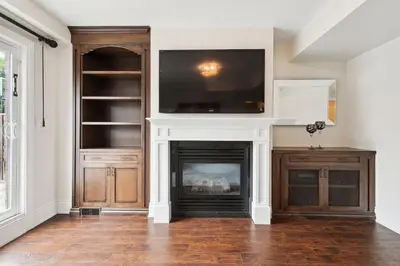 a living room with a fireplace with a tv above it at Quiet Getaway Perfect for Families and Retreats in Mississauga