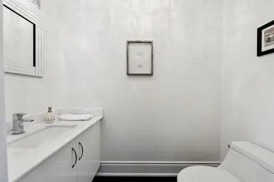 a white bathroom with a sink and a toilet at Quiet Getaway Perfect for Families and Retreats in Mississauga