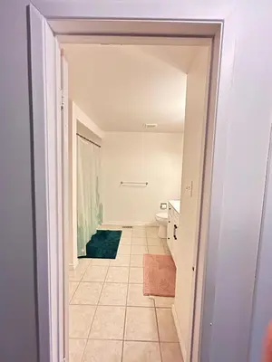 a hallway leading to a bathroom with a toilet at Cozy Ajax Stay for Families in Ajax