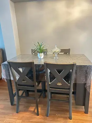 a dining room table and chairs with a marble table and a table and chairsktop at Cozy Ajax Stay for Families in Ajax