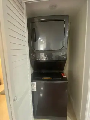 a small tv sitting on top of a refrigerator at Cozy Two-Bedroom Luxury Suite near Toronto Airport in Mississauga