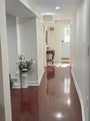 a hallway of a home with a tile floor at Cozy Two-Bedroom Luxury Suite near Toronto Airport in Mississauga