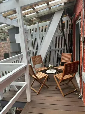 two chairs and a table on a porch at The Bloor Spadina Getaway With 3-Bedroom and Private Patio in Toronto