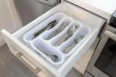 a white drawer with cutlery in it in a kitchen at The Bloor Spadina Getaway With 3-Bedroom and Private Patio in Toronto