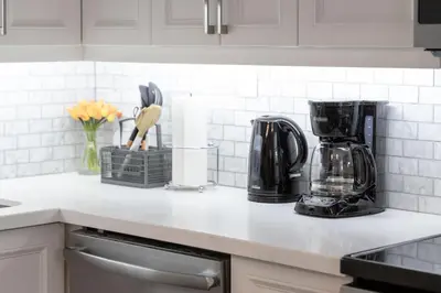 a kitchen counter with a coffee maker on it at The Bloor Spadina Getaway With 3-Bedroom and Private Patio in Toronto