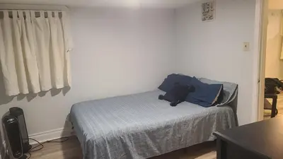a bedroom with a bed with a teddy bear on it at 132 Chatham ave in Toronto