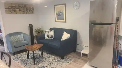a living room with a blue couch and a chair at 132 Chatham ave in Toronto
