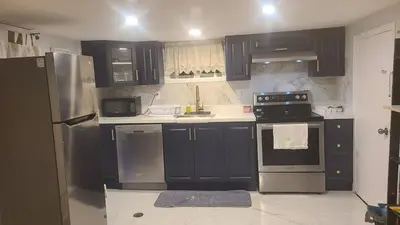 a kitchen with black and stainless steel appliances at 132 Chatham ave in Toronto