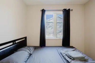 a bedroom with a bed and a window at 2-Bedroom Cottage #10 - Pitch Pine in Gravenhurst