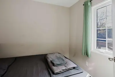 a bed in a room with a window at 3-Bedroom Cottage #7 - Austrian Pine in Gravenhurst