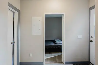 a bedroom with a door leading to a bed at 3-Bedroom Cottage #7 - Austrian Pine in Gravenhurst