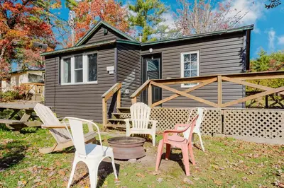 a group of chairs in front of a house at 3-Bedroom Cottage #7 - Austrian Pine in Gravenhurst