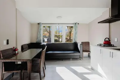 a living room with a couch and a table at 3-Bedroom Cottage #7 - Austrian Pine in Gravenhurst