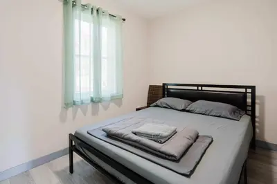 a bed with two pillows on it in a bedroom at 3-Bedroom Cottage #7 - Austrian Pine in Gravenhurst