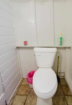 a bathroom with a white toilet in a room at 1-Bedroom Cottage #1 - White Pine in Gravenhurst