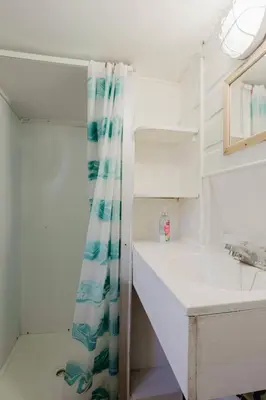 a bathroom with a sink and a shower curtain at 1-Bedroom Cottage #1 - White Pine in Gravenhurst