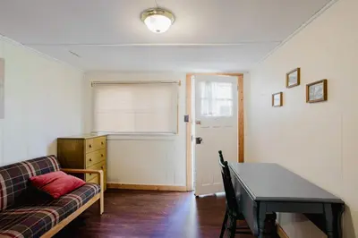 a living room with a couch and a table at 1-Bedroom Cottage #1 - White Pine in Gravenhurst