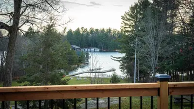 a view of a lake from a wooden fence at Lake Muskoka 2-bedroom Cottage - Pier 100 #50 in Port Carling