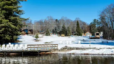 a snow covered area with a dock and a snow covered field at Lake Muskoka 2-bedroom Cottage - Pier 100 #50 in Port Carling